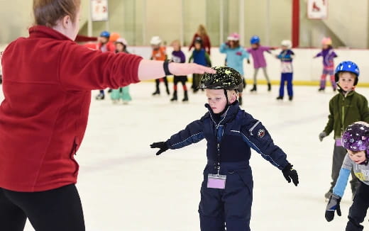 a person and a child ice skating