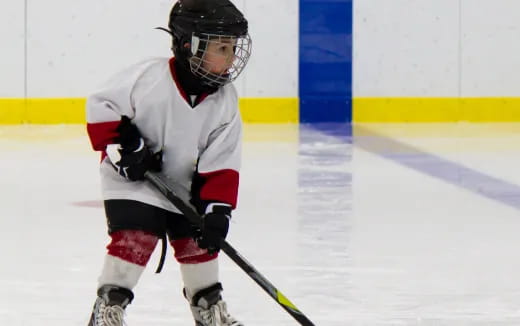 a young boy playing hockey