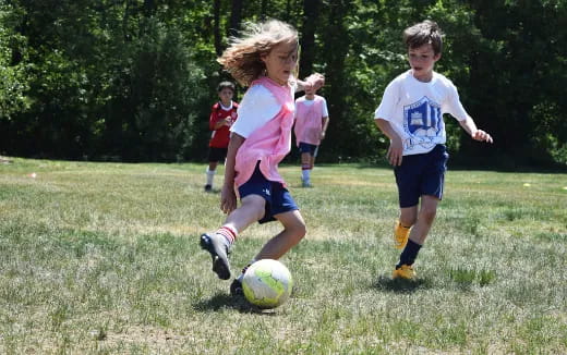 kids chasing a football ball
