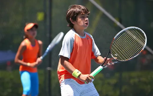 a boy playing tennis