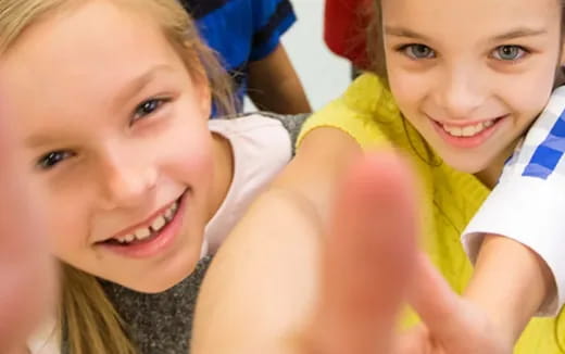 a couple of children smiling