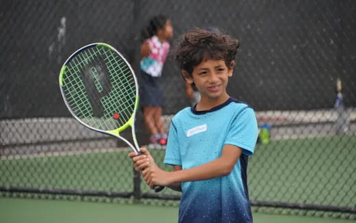a young girl playing tennis