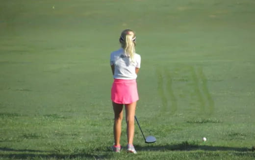 a woman playing golf