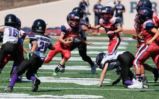 a group of kids playing football