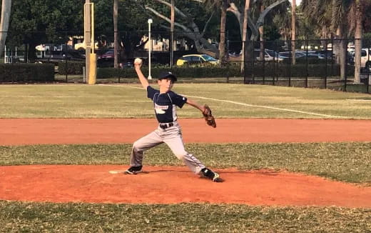 a kid pitching a baseball