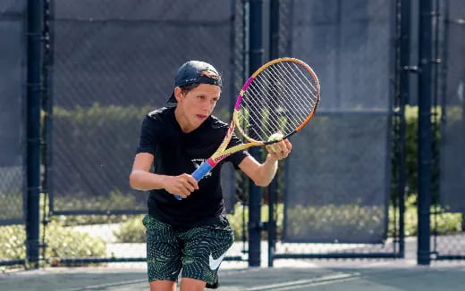 a boy playing tennis