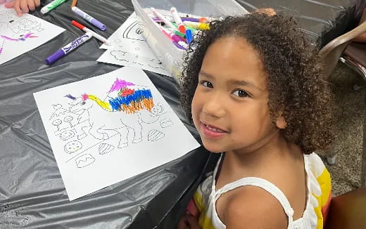 a girl holding a drawing