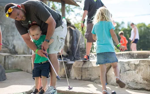 a person and a child playing with a toy