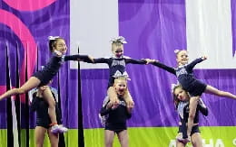 a group of girls performing on a stage