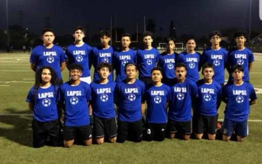 a group of people in blue shirts