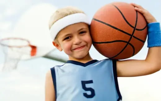 a boy holding a basketball