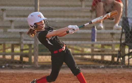 a young girl playing baseball