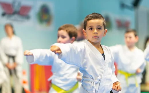 a boy in a karate uniform