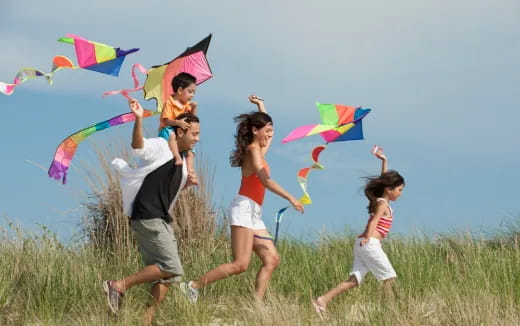 a family running with kites