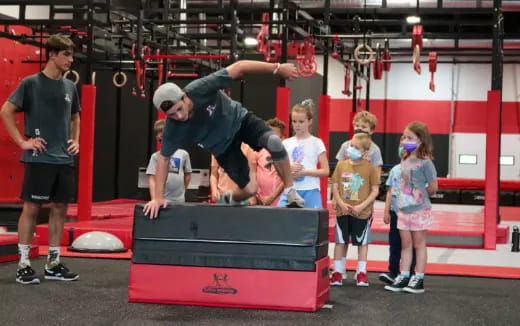 a person doing a handstand on a bar