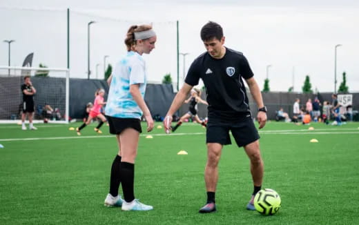 a man and a woman playing football
