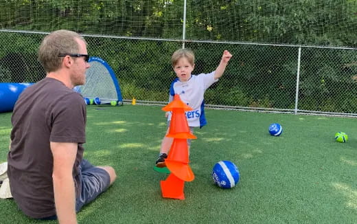 a person and a child playing football