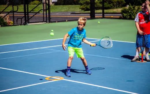 a boy playing tennis
