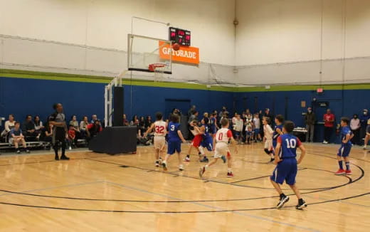 a group of people playing basketball