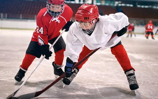 two people playing hockey