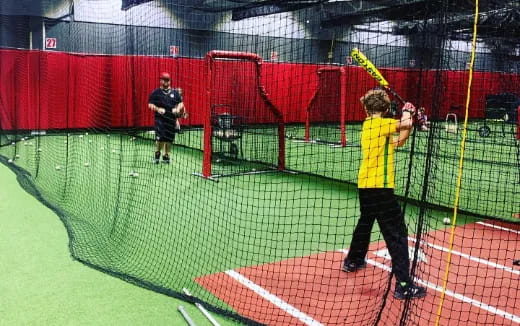 a boy swinging a baseball bat
