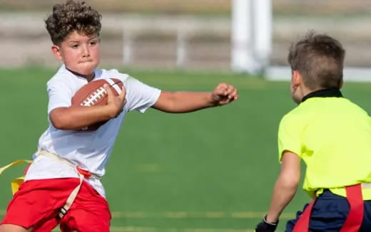 a boy running with a football