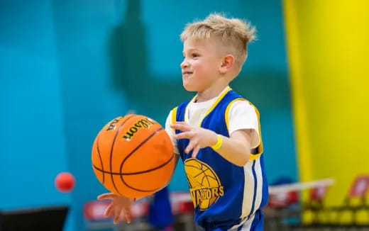 a boy holding a basketball