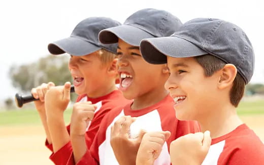 a group of boys wearing baseball caps