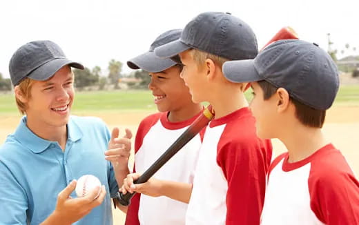 a group of kids playing baseball