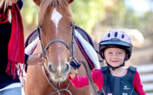 a boy holding a horse