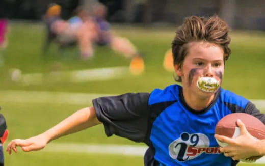 a person with a mustache and a football