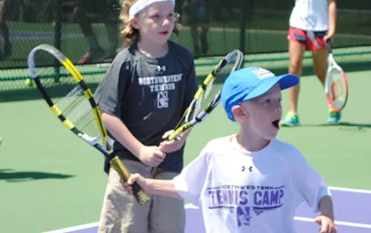 kids holding tennis rackets