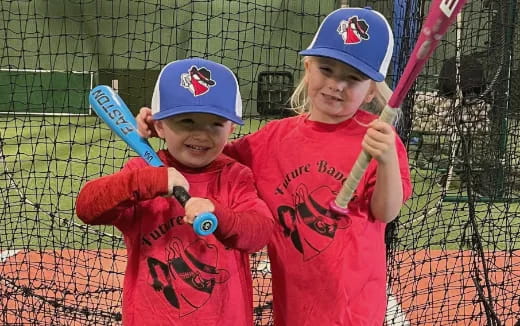kids holding baseball bats