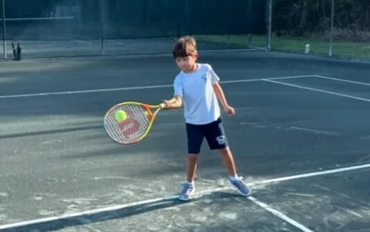 a boy playing tennis