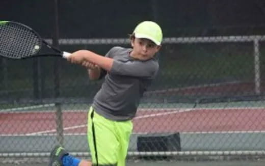 a boy playing tennis