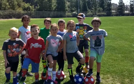 a group of kids playing football