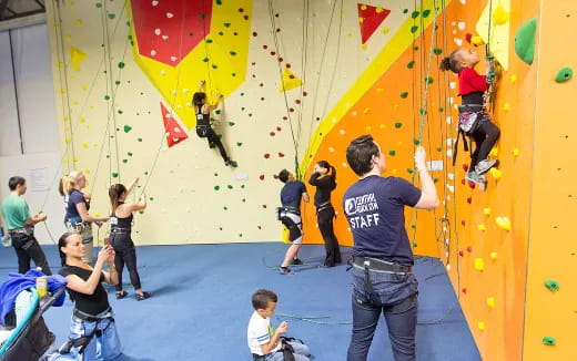 a group of people climbing a wall