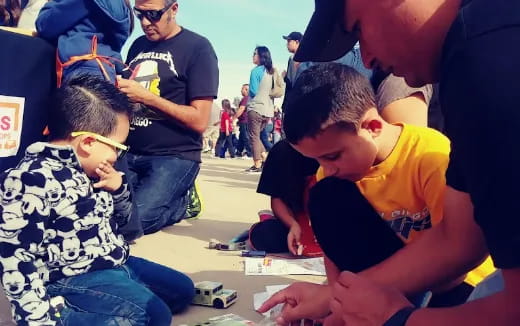 a group of people looking at a paper
