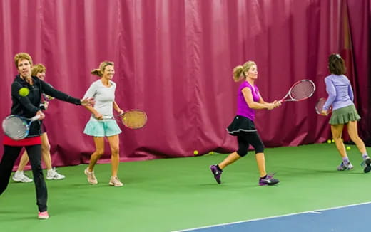 women playing tennis on a court