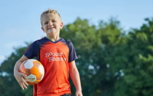 a boy holding a ball