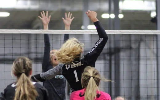 a group of girls raising their hands