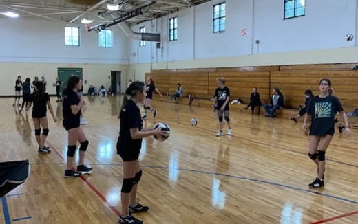 a group of people playing volleyball