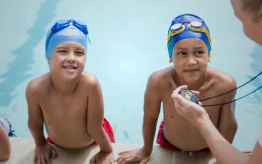a group of boys in swimsuits