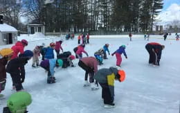 a group of people playing in the snow