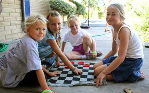 a group of children sitting on the ground