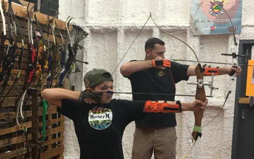 a person holding a gun and another man holding a gun