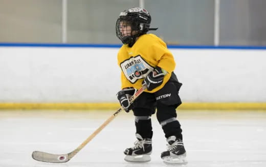 a young boy playing hockey