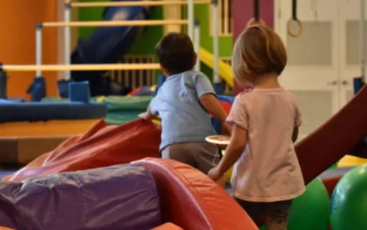 a couple of kids playing on a playground