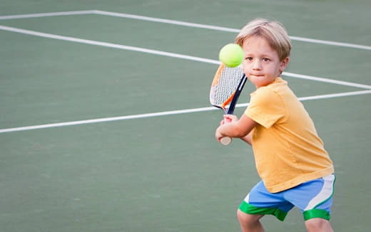 a boy playing tennis