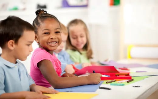a group of children sitting at a table